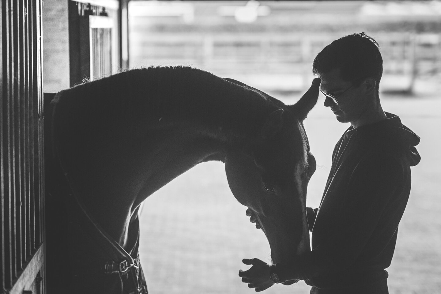 Marten Luiten knuffelt zijn paard in de opening van diens stal